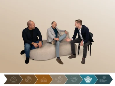 MVO bij ATO. Ethische bedrijfsvoering & kwaliteit. Op de foto drie mannelijke mangers in gesprek zittend op een moderne zithoek tegen neutrale achtergrond.